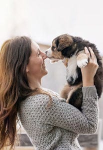 woman holding puppy