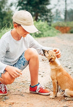 boy petting dog